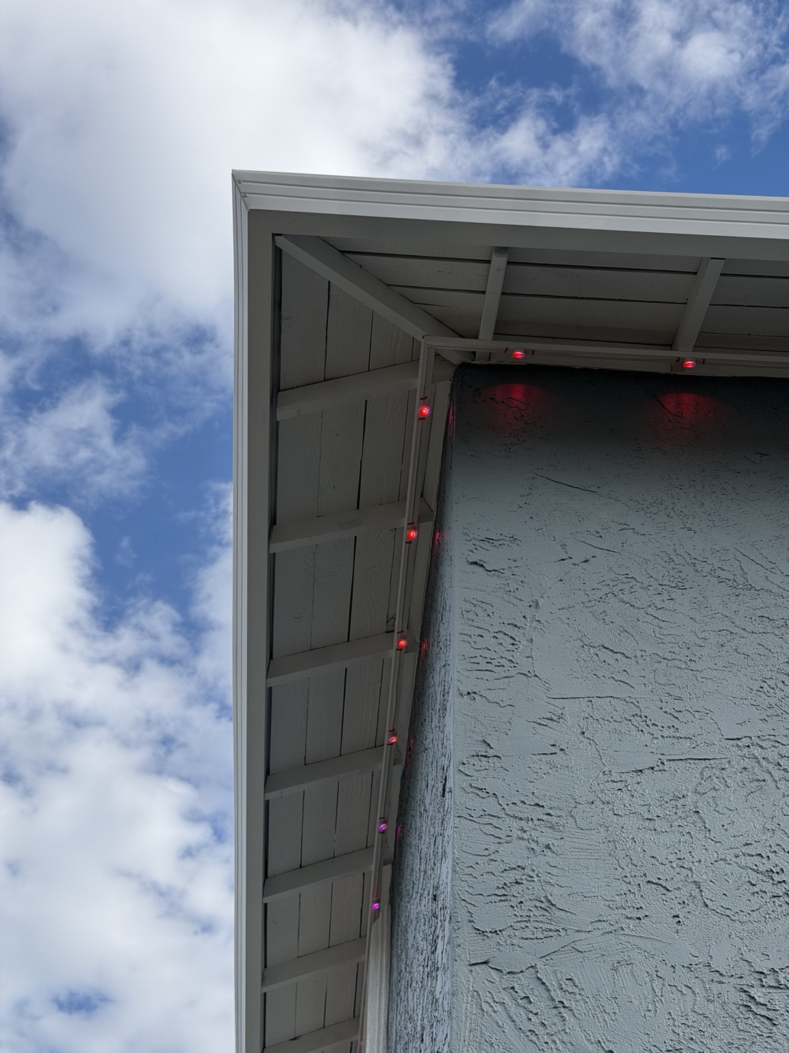 Permanent Govee lights installed on color-matched white mounting boards under an eave